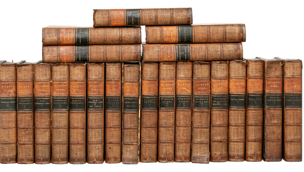 An antique collection of twenty-two leather bound and gilded books by Charles Dickens